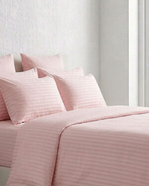 Luxury pink sateen striped Egyptian cotton bedding set on a modern bed